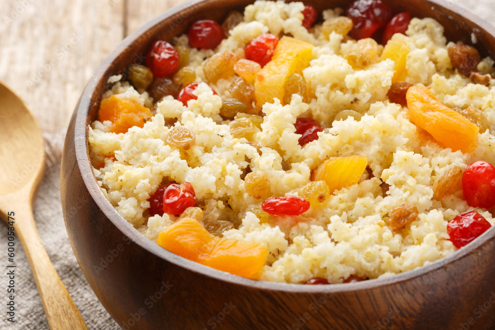 Millet with dried fruits and berry close-up in a bowl on the table. Horizontal Millet with dried fruits and berry close-up in a bowl on the table. Horizontal