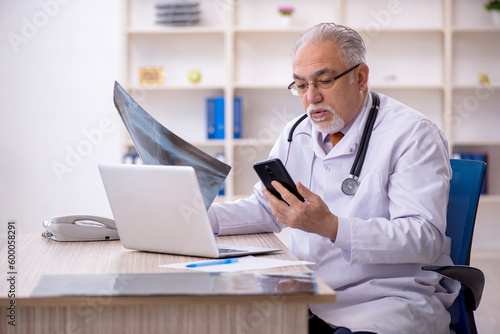 Old male doctor radiologist working in the clinic