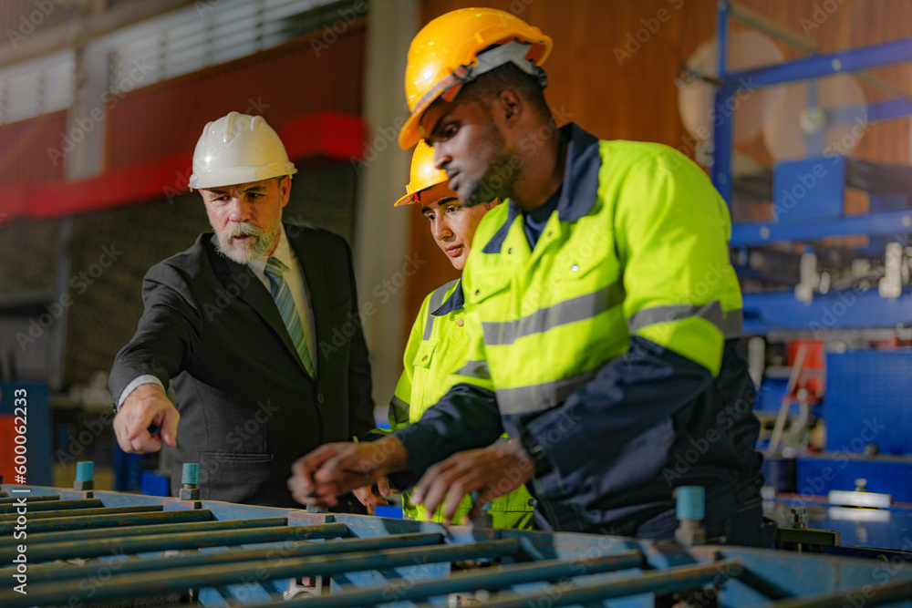 Senior boss manager inspecting with staff engineers woman and African ...