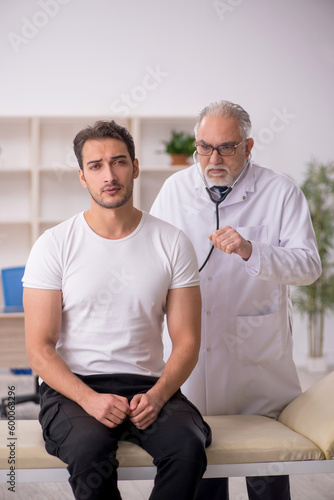 Young male patient visiting old male doctor