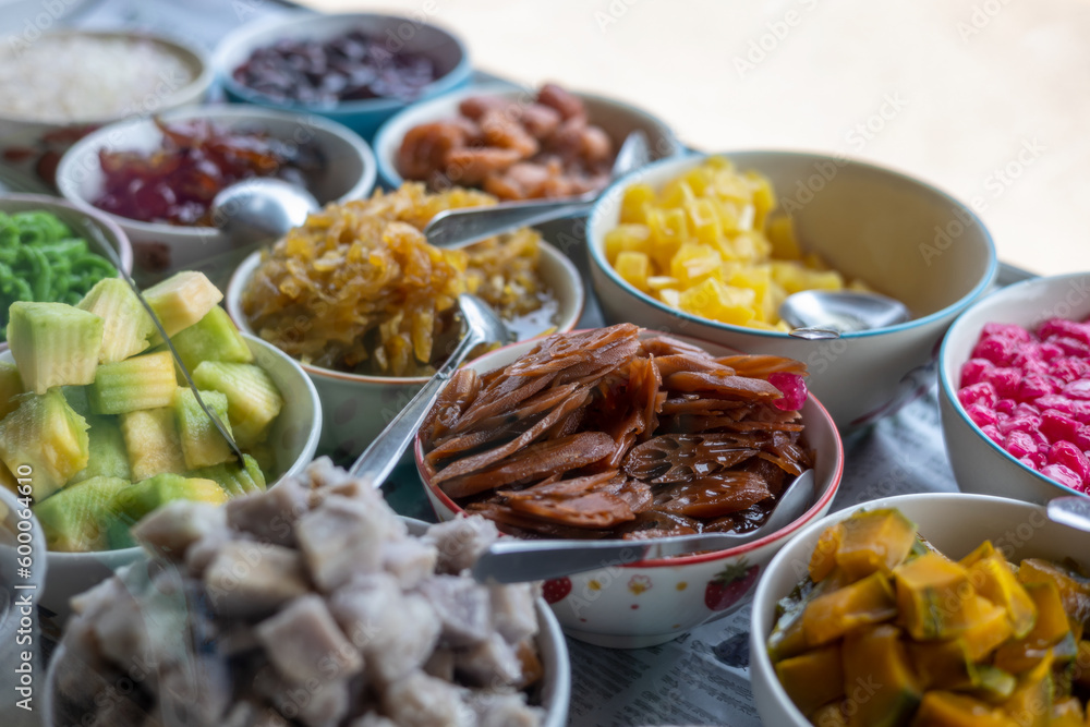 Close-up view of slices of pineapple and lotus root in glazed syrup and a variety.