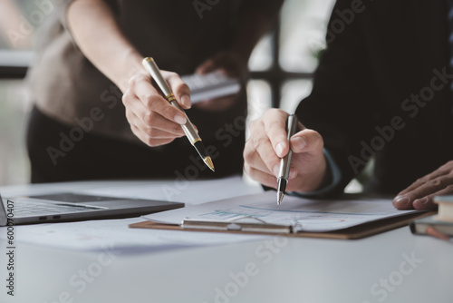 Businessman is reviewing monthly sales documents for analysis and marketing plans for more sales growth, they are the founders of young companies co-founding startups. Sales management concept.