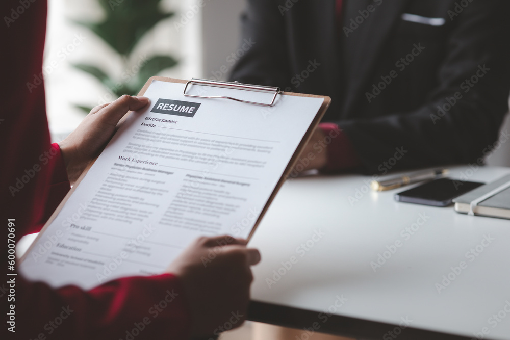 Person submitting resume to interview for a job with a company, Person attending a job interview with a manager to be recruited to the company for the position applied for. Job application concept. Person submitting resume to interview for a job with a company, Person attending a job interview with a manager to be recruited to the company for the position applied for. Job application concept.