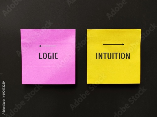 Pink and yellow note with text LOGIC and INTUITION point to different direction,  concept of choosing logic to make decision or follow instinct trusting intuition which valuable in some circumstance