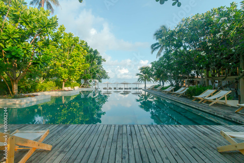 Photography Sea landscape view of a tropical resort hotel beside modern swimming pool, white
