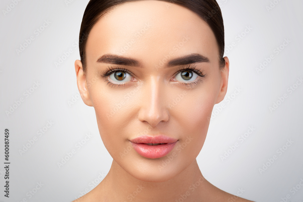 Portrait Of European Woman Looking At Camera On Gray Background Portrait Of European Woman Looking At Camera On Gray Background