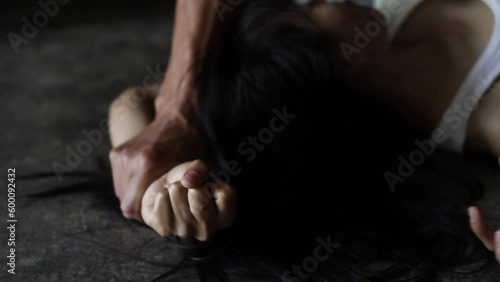 Man's hand holding woman's hand for rape and sexual harassment.A social problem or concept.Women are victims of violence.