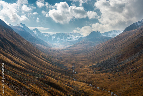 A valley and stream between mountains. trovit plateau