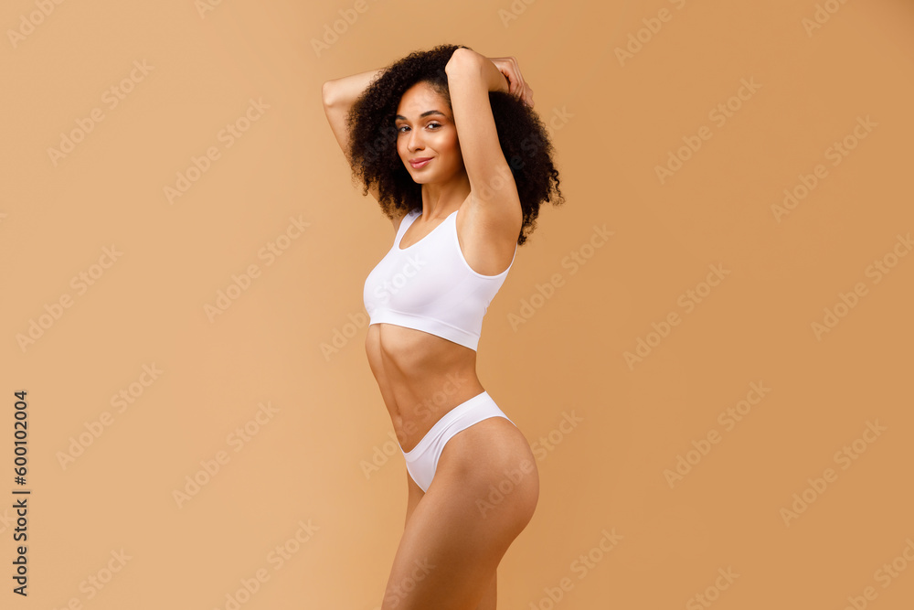 Skincare and radiance. Glowing black lady with perfect body figure