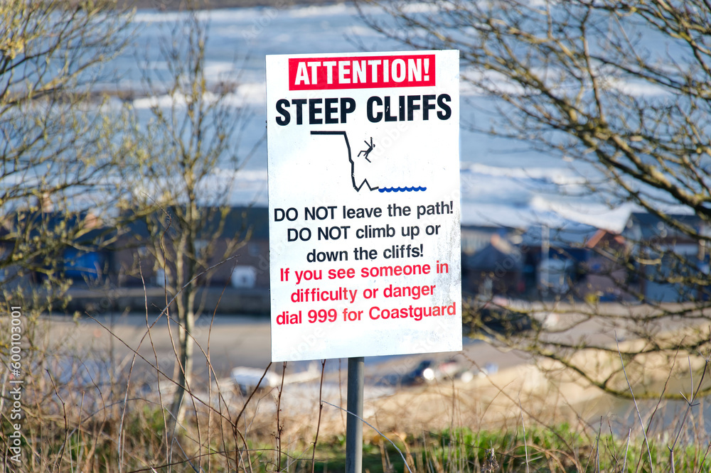 Steep cliffs warning sign for tourists high above Stonehaven harbour