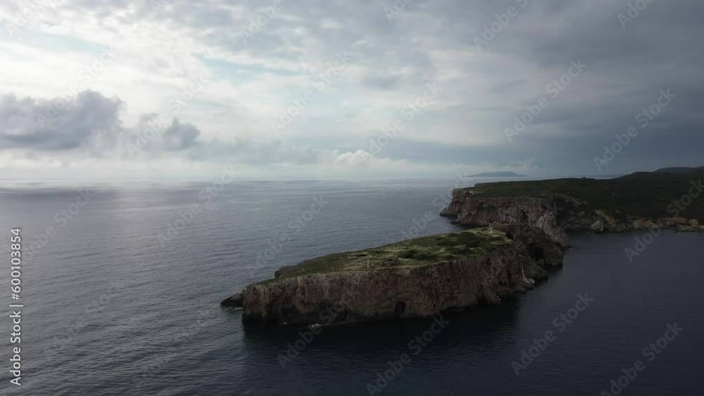 Breathtaking aerial sunset view of the Historical rocky limestone Tsichli-Baba island south of Sphacteria where is the erected monument to the French fallen sailors in the Battle of Navarino Breathtaking aerial sunset view of the Historical rocky limestone Tsichli-Baba island south of Sphacteria where is the erected monument to the French fallen sailors in the Battle of Navarino