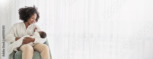 Close up portrait of beautiful young African American  mother holding sleep newborn baby in hospital bed room. Healthcare medical love black afro woman lifestyle mother's day, breast with copy space.