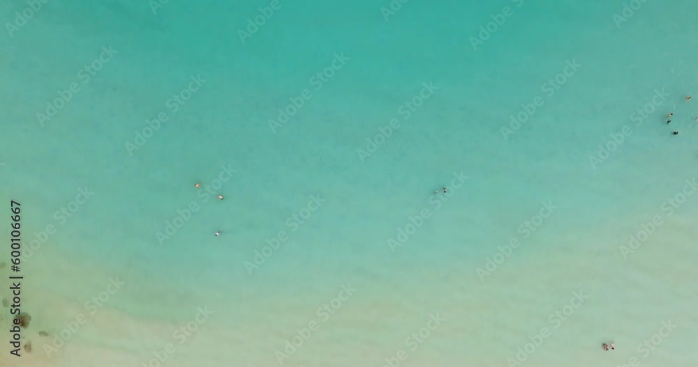 Aerial drone view of clear turquoise sea and waves over the beach. Aerial drone view of clear turquoise sea and waves over the beach.