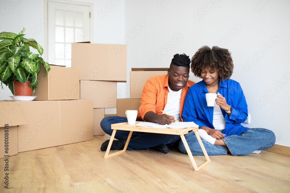 Young Black Family Couple Planning Shopping For New Home, Making Checklist Young Black Family Couple Planning Shopping For New Home, Making Checklist