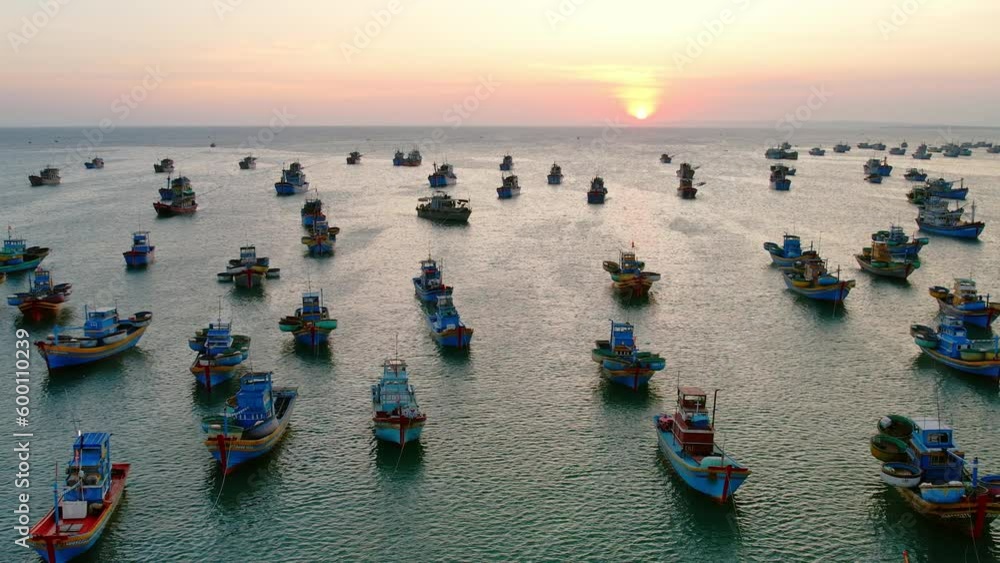 Aerial view of Mui Ne fishing village in sunset sky with hundreds of boats anchored to avoid storms, this is a beautiful bay in central Vietnam Aerial view of Mui Ne fishing village in sunset sky with hundreds of boats anchored to avoid storms, this is a beautiful bay in central Vietnam