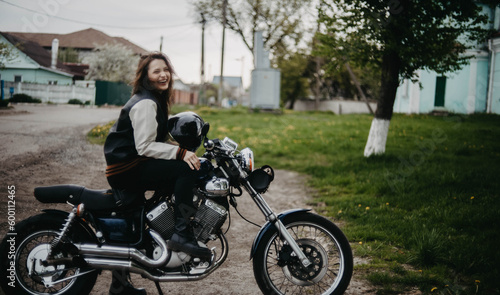 beautiful woman motorcyclist on a vintage custom motorcycle. Woman biker