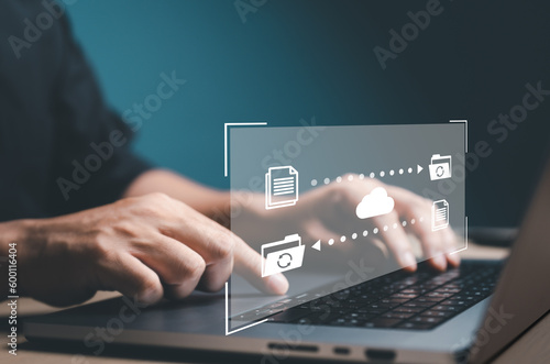 Data Transfer concept. FTP (File Transfer Protocol) files receiver and computer backup. Office man use laptop to copy or sharing document data. Digital system for transferring documents files online.