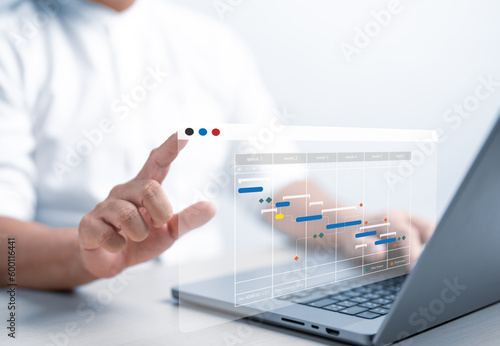 Project management or Engineer working with proceeding report concept. Site manager use planning software to make with Gantt chart schedule for update progress construction and operations plan tasks.