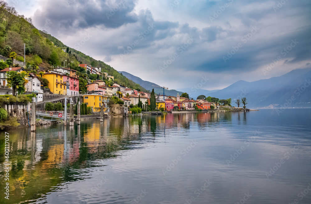 Small colorful village with water reflection on Lake Maggiore.