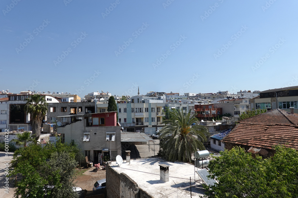 Typical Turkish cityscape with dense standing houses in poor condition view from the window in bright cloudless day