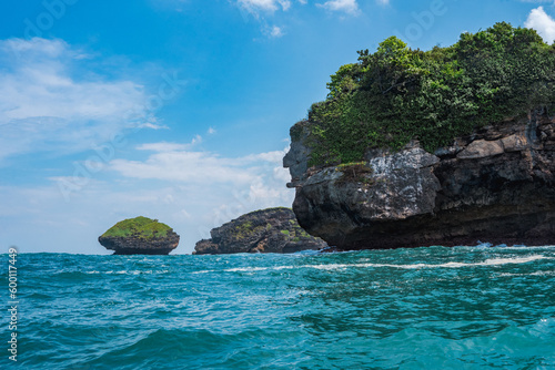 Rock formation on the ocean near the Tanjung Kasap or Cape Kasap, Pacitan, Indonesia. Taken from a moving boat.