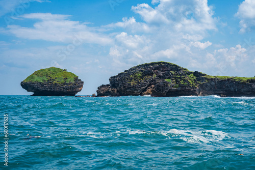 Rock formation on the ocean near the Tanjung Kasap or Cape Kasap, Pacitan, Indonesia. Taken from a moving boat.