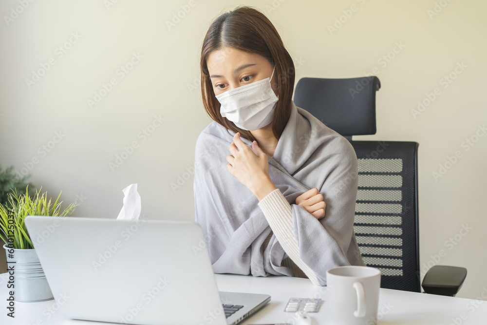 Sick asian young woman wearing mask wrapped blanket have headache have fever, flu and using laptop computer consulting with doctor online, telehealth at home. Health care people on virus seasonal. Sick asian young woman wearing mask wrapped blanket have headache have fever, flu and using laptop computer consulting with doctor online, telehealth at home. Health care people on virus seasonal.