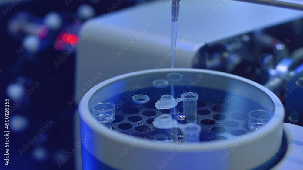 Apparatus for automatic sampling, analysis. A robo hand takes a sample