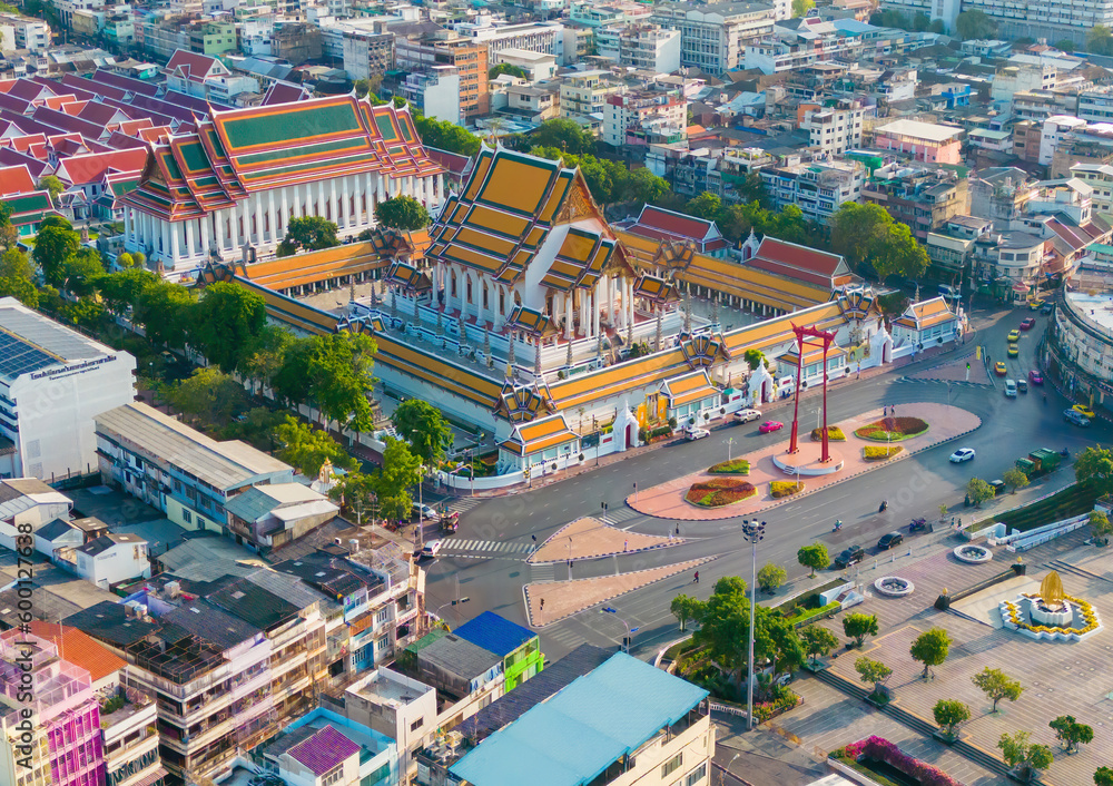 Aerial top view of Giant Swing or Sao Ching Cha monument with Wat Suthat temple at sunset in old town, Bangkok City, Thailand. Landmark tourist attraction. Thai architecture with travel trip concept.