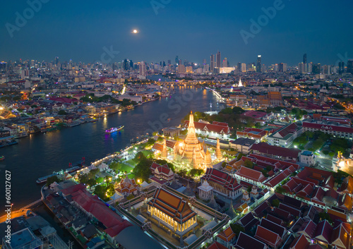Aerial top view of Temple of Dawn or Wat Arun statue and Chao Phraya River, Bangkok, Thailand in Rattanakosin Island in architecture, Urban old town city, skyline at sunset. © tampatra