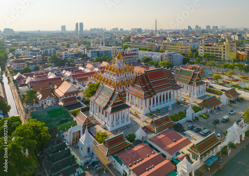 Photography Aerial top view of Wat Ratchanatdaram Pagoda, a buddhist temple or Wat Saket in Bangkok Downtown, urban city with sunset sky, Thailand