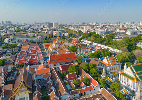 Aerial top view of Wat Ratchanatdaram Pagoda, a buddhist temple or Wat Saket in Bangkok Downtown, urban city with sunset sky, Thailand. Thai architecture landscape background.