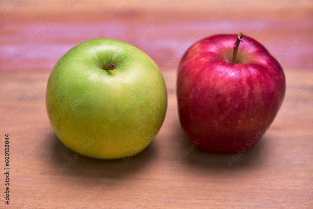 Fresh green and red apples laying on wooden table. Food concept, vegetables and fruits for weight loss, health promotion. Fresh green and red apples laying on wooden table. Food concept, vegetables and fruits for weight loss, health promotion.