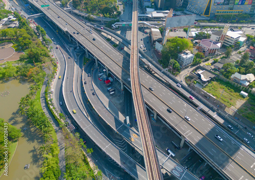 Aerial view of cars driving on Ladprao highway junction or moterway. Overpass bridge street roads in connection network of architecture concept. Top view. Urban city, Bangkok, Thailand.