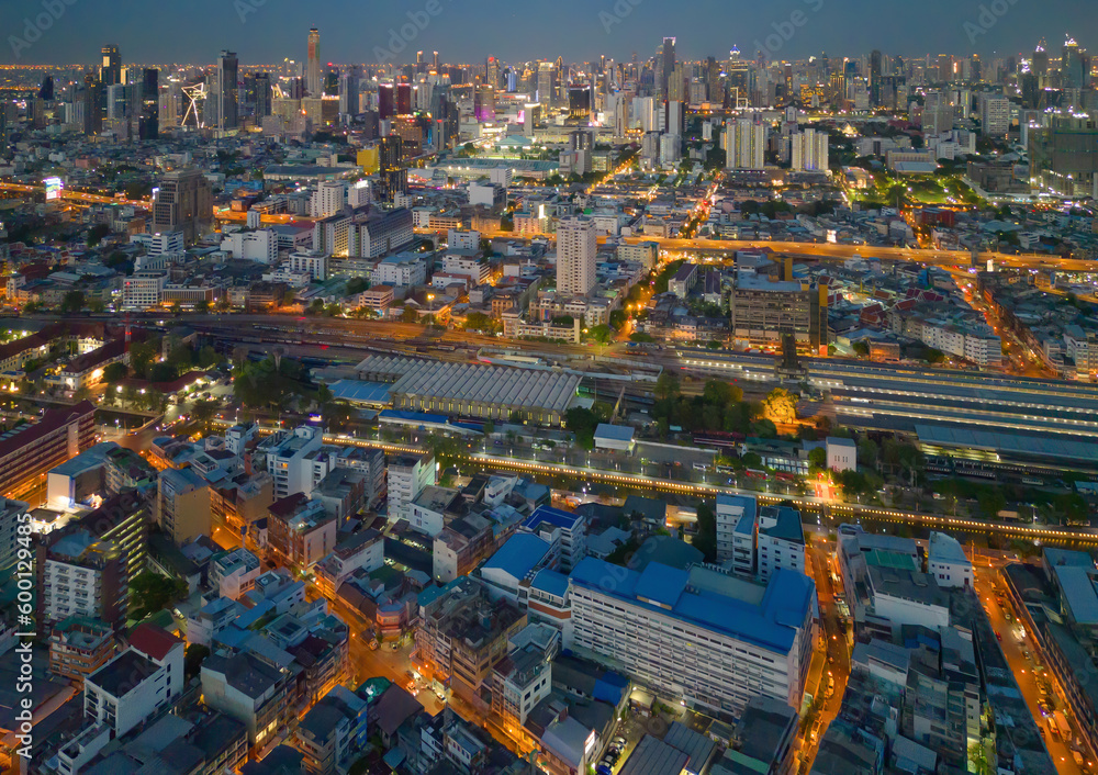 Aerial view of Bangkok Downtown skyline, highway roads or street in Thailand. Financial district and business area in smart urban city. Skyscraper and high-rise buildings at night.
