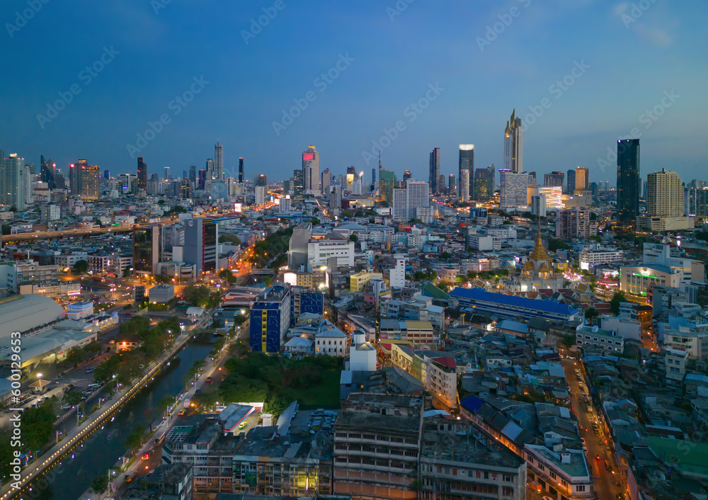 Fototapeta premium Aerial view of Bangkok Downtown skyline, highway roads or street in Thailand. Financial district and business area in smart urban city. Skyscraper and high-rise buildings at night.