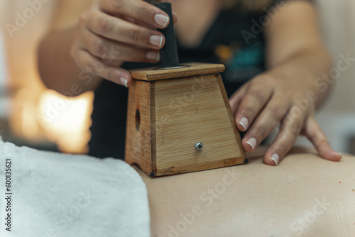 Moxibustion treatment: Traditional Chinese medicine tools for heating acupuncture point therapy. chinese herbal medicine Copper moxibustion burner box with herbal moxa sticks in holistic clinic.