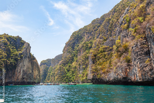 A picturesque beautiful place on the island of Phi Phi Leh - Pi Leh Lagoon is popular for excursions with tourists on traditional Thai fishing boats. Island travel in Thailand.
