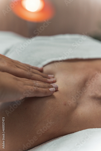 Relaxing woman shoulder massage with physiotherapist in clinic center