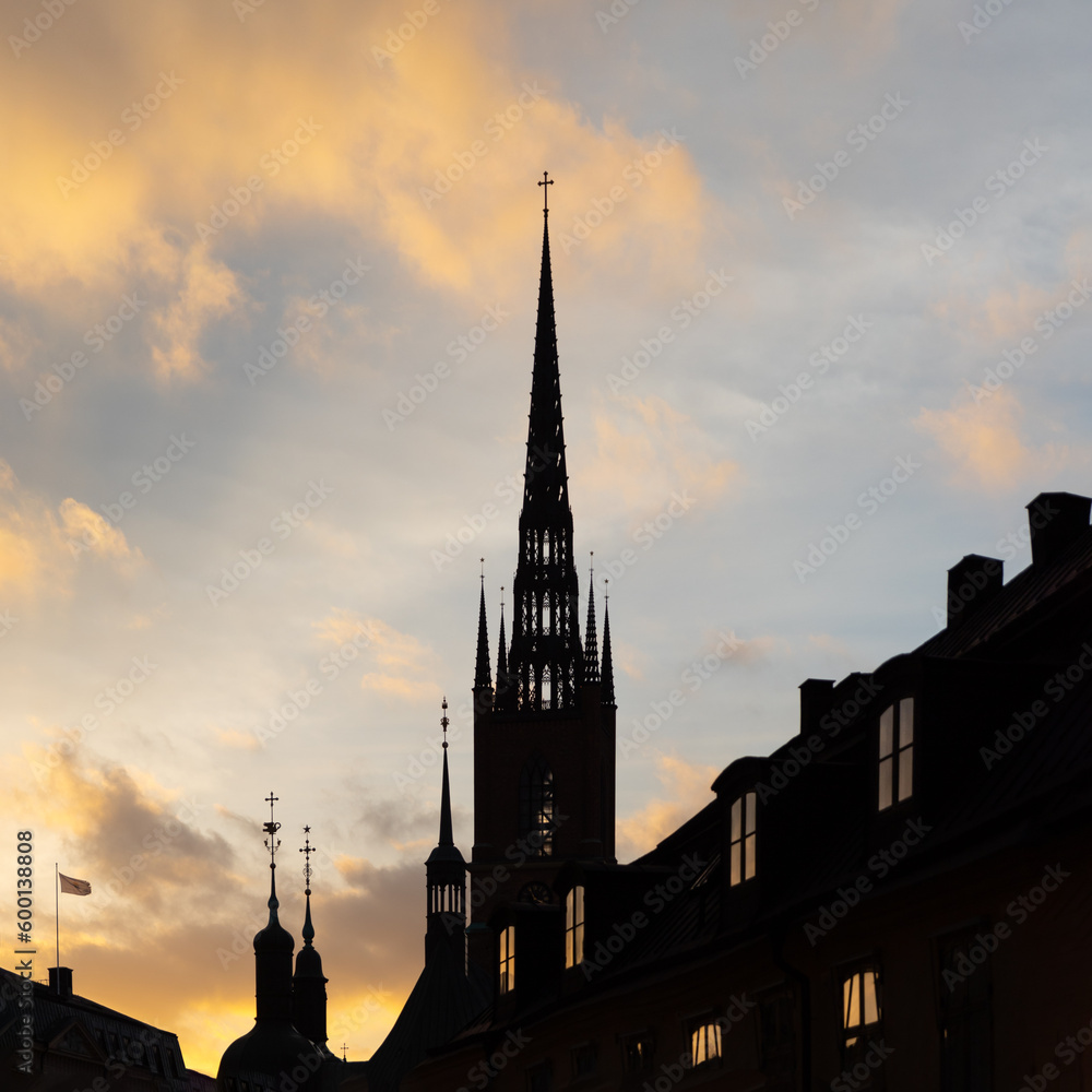 Majestic spires dominate city skyline at sunset, creating captivating silhouettes against the vibrant evening sky. Majestic spires dominate city skyline at sunset, creating captivating silhouettes against the vibrant evening sky.