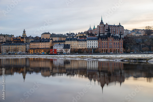 The tranquil sea mirrors the serene charm of the shore houses in Stockholm, creating a captivating reflection of peace and beauty.