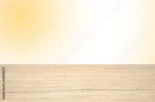 Empty wooden table isolated on blurred empty orange background.