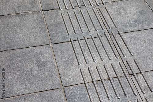 Pavement with tactiles . City sidewalk background