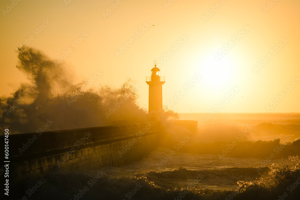 Backlit view of the Lighthouse of Felgueiras during a golden sunset, Porto, Portugal..