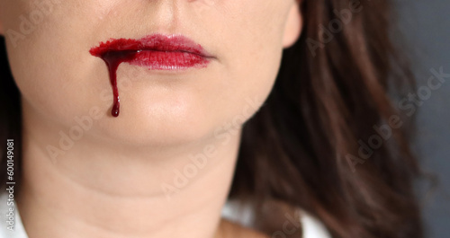 Close up photo of bloody female lips. Halloween theme 