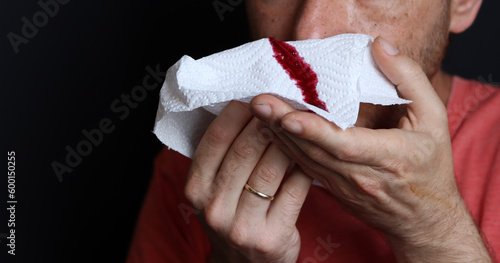 Man holding a bloody handkerchief in his hand, closeup
