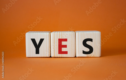 Yes symbol. Wooden blocks with word yes. Beautiful orange background. Business and yes concept. Copy space.