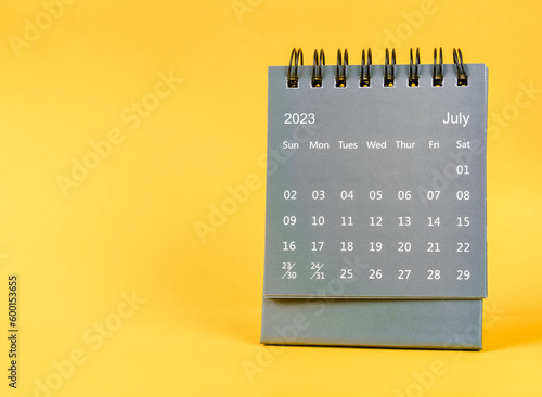 The July 2023 Monthly desk calendar for 2023 year on yellow background.