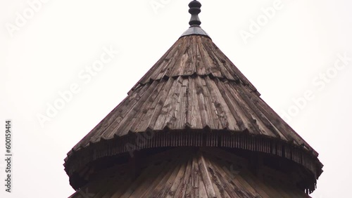 Closeup shot of the top portion of the Tripura Sundari Temple at Naggar near Manali in Himachal Pradesh, India. Top of the wooden temple in front of the pine trees on the mountains in Himachal.  photo