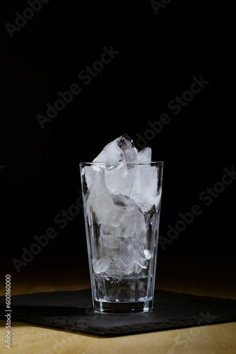 Glass with ice for an alcoholic cocktail, close-up